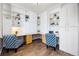 Office with custom built-ins, wood floors, and designer chairs at 9745 Hummingbird Pl, Littleton, CO 80125