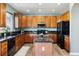 Spacious kitchen with wood cabinets, stainless steel appliances, granite counters, and a center island at 9745 Hummingbird Pl, Littleton, CO 80125