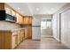 Kitchenette with wood cabinets, light countertops, a white refrigerator, and wood-look flooring at 9745 Hummingbird Pl, Littleton, CO 80125