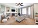 Cozy living room with fireplace, modern furnishings, and light-filled windows at 9745 Hummingbird Pl, Littleton, CO 80125