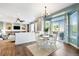 Open concept living space with wood floors and a cozy fireplace, perfect for entertaining at 9745 Hummingbird Pl, Littleton, CO 80125