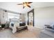 Main bedroom suite with neutral walls, carpet, ceiling fan and ensuite bath at 9745 Hummingbird Pl, Littleton, CO 80125