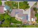 Aerial view of a stunning property with a pool, patio, solar panels, and lush landscaping at 10380 W Warren Ave, Lakewood, CO 80227
