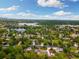 Stunning aerial view of a neighborhood with lakes and lush trees, showcasing community charm at 10380 W Warren Ave, Lakewood, CO 80227