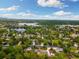 Scenic aerial view showcases a neighborhood with lush greenery, tranquil lakes, and charming homes at 10380 W Warren Ave, Lakewood, CO 80227