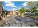 Expansive backyard featuring flagstone patio, firepit area, lush landscaping, and privacy fence at 10380 W Warren Ave, Lakewood, CO 80227