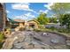 An inviting backyard features a stone patio, fire pit, and a shady pergola for outdoor relaxation and entertainment at 10380 W Warren Ave, Lakewood, CO 80227