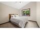 Cozy bedroom featuring natural light, vaulted ceiling, and neutral tones creating a relaxing atmosphere at 10380 W Warren Ave, Lakewood, CO 80227
