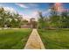 Charming ranch-style home with stone walkway and mature trees, offering a warm and inviting curb appeal at 10380 W Warren Ave, Lakewood, CO 80227