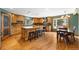 Well-lit kitchen with wood cabinets, granite counters, large center island with seating, and stainless steel appliances at 10380 W Warren Ave, Lakewood, CO 80227