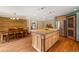 Spacious kitchen with a large island, stainless steel appliances, and hardwood floors at 10380 W Warren Ave, Lakewood, CO 80227