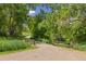 Scenic walking path with a wooden fence, surrounded by lush greenery, perfect for outdoor recreation at 10380 W Warren Ave, Lakewood, CO 80227