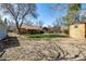 Expansive backyard featuring lush greenery and a covered patio, perfect for outdoor entertaining and relaxation at 620 Newport St, Denver, CO 80220