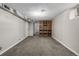 Finished basement with carpet and shelving at 620 Newport St, Denver, CO 80220
