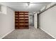 Finished basement with carpet and shelving at 620 Newport St, Denver, CO 80220