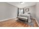 Cozy bedroom with hardwood floors, neutral decor, and a large window at 620 Newport St, Denver, CO 80220