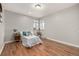 Bright bedroom with wood floors, a corner window, and neutral colored walls at 620 Newport St, Denver, CO 80220