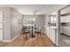 Cozy dining area with hardwood floors, large window, and open access to the updated kitchen at 620 Newport St, Denver, CO 80220