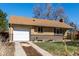 A ranch-style brick house with a well-kept yard and long driveway leading to the attached one-car garage at 620 Newport St, Denver, CO 80220