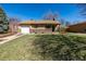 Charming brick ranch-style home with attached garage and mature trees in a well-maintained neighborhood at 620 Newport St, Denver, CO 80220