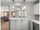Pass through from updated kitchen showing breakfast bar into living area at 620 Newport St, Denver, CO 80220