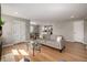 Bright open-concept living room with hardwood floors, and an open view of the dining area and kitchen at 620 Newport St, Denver, CO 80220
