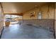 Covered patio area with brick wall and partial fencing at 620 Newport St, Denver, CO 80220