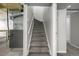 Carpeted stairs leading to basement with utility features visible at 620 Newport St, Denver, CO 80220