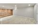 Spacious carpeted basement featuring a red brick accent wall, and recessed lighting at 1030 Kohl St, Broomfield, CO 80020