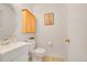 Charming half bathroom with a vanity, toilet, and decorative cabinet at 1030 Kohl St, Broomfield, CO 80020