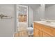 Bathroom with wood vanity, toilet and doorway to basement at 1030 Kohl St, Broomfield, CO 80020