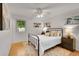 Inviting bedroom with a metal frame bed, soft lighting, and wood floors at 1030 Kohl St, Broomfield, CO 80020