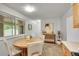 Cozy dining area with light wood table, four chairs, and modern sideboard at 1030 Kohl St, Broomfield, CO 80020