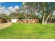 Charming single-story home with a well-manicured front lawn and mature trees at 1030 Kohl St, Broomfield, CO 80020