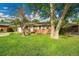 Inviting single-story home with well-kept lawn, mature trees, and brick accents at 1030 Kohl St, Broomfield, CO 80020