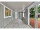 Bright sunroom with wood-look floors, sliding glass doors, and backyard view at 1030 Kohl St, Broomfield, CO 80020