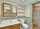 Bathroom featuring a vanity, toilet, shelves, and shower with glass door at 3426 W 98Th W Dr # A, Westminster, CO 80031