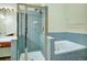 Modern bathroom featuring a glass-enclosed shower, separate bathtub, and vanity area, designed for relaxation and convenience at 3426 W 98Th W Dr # A, Westminster, CO 80031