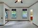 Bright bedroom with dual windows and a ceiling fan for optimal comfort, complemented by a floral wallpaper border at 3426 W 98Th W Dr # A, Westminster, CO 80031