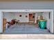 A spacious garage, painted white with concrete floor, containing storage and an exit door at 3426 W 98Th W Dr # A, Westminster, CO 80031