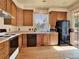 Functional kitchen with wood cabinets and black appliances at 3426 W 98Th W Dr # A, Westminster, CO 80031