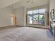 Bright living room featuring a fireplace, large windows, and neutral carpeting at 3426 W 98Th W Dr # A, Westminster, CO 80031