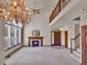 Spacious living room with vaulted ceiling, fireplace, and elegant chandelier at 3426 W 98Th W Dr # A, Westminster, CO 80031
