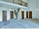 Spacious living room featuring high ceilings, a staircase, and a beautiful chandelier, perfect for entertaining guests at 3426 W 98Th W Dr # A, Westminster, CO 80031