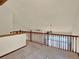 View of the loft featuring wood railing, vaulted ceilings, and a ceiling fan at 3426 W 98Th W Dr # A, Westminster, CO 80031
