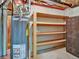 Utility room with a water heater, unfinished walls, shelving unit and storage cabinet at 3426 W 98Th W Dr # A, Westminster, CO 80031