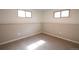 Cozy bedroom with neutral tones, chair rail, and plush carpeting; natural light from two windows at 2300 S Krameria St, Denver, CO 80222