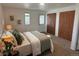 Bedroom with soft lighting and earth tone colors and a view of nature through the windows at 2300 S Krameria St, Denver, CO 80222