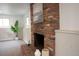 Finished basement with exposed brick fireplace and neutral color palette, perfect for relaxation at 2300 S Krameria St, Denver, CO 80222