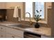 Close-up of a modern kitchen sink with stylish gold faucet and tile backsplash under a bright window at 2300 S Krameria St, Denver, CO 80222